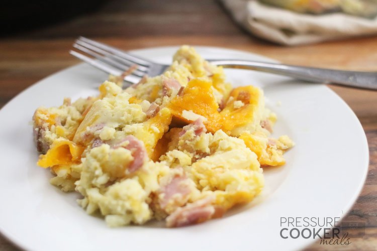 Instant Pot Breakfast Casserole with Ham and Egg on white plate with fork