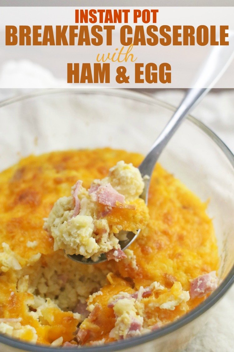 Instant Pot Breakfast Casserole with Ham & Egg in a clear bowl with a spoon dipping