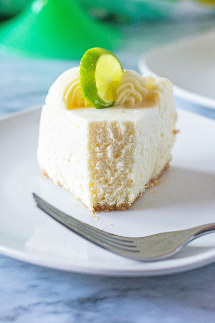 Slice of Instant Pot Key Lime Cheesecake with missing bite
