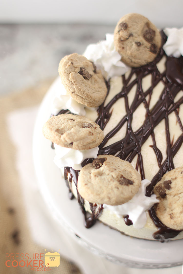 This Instant Pot Chocolate Chip Cookie Dough Cheesecake with ganache, chocolate chip cookies and whipped cream on top