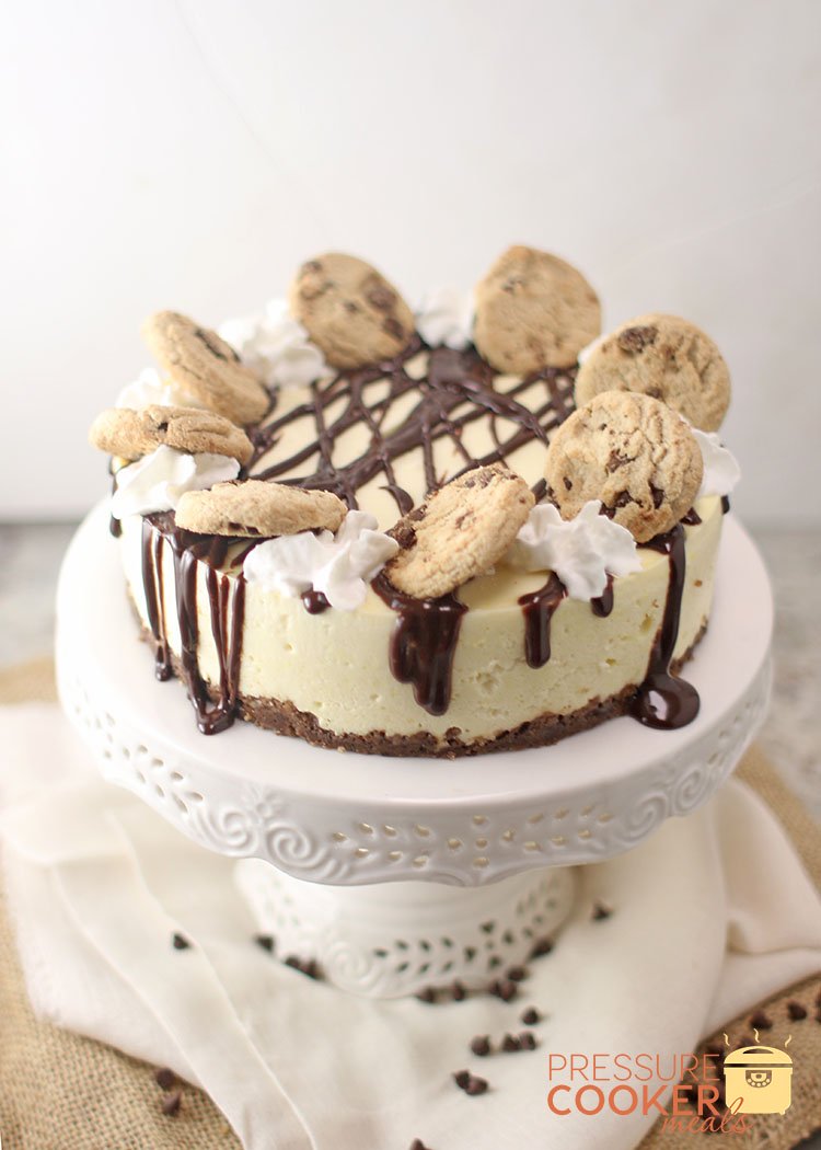 Instant Pot Chocolate Chip Cookie Dough Cheesecake with ganache, chocolate chip cookies and whipped cream on top