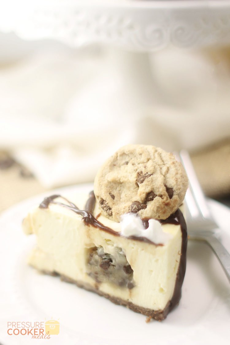 slice of Instant Pot Chocolate Chip Cookie Dough Cheesecake with ganache, chocolate chip cookies and whipped cream on top