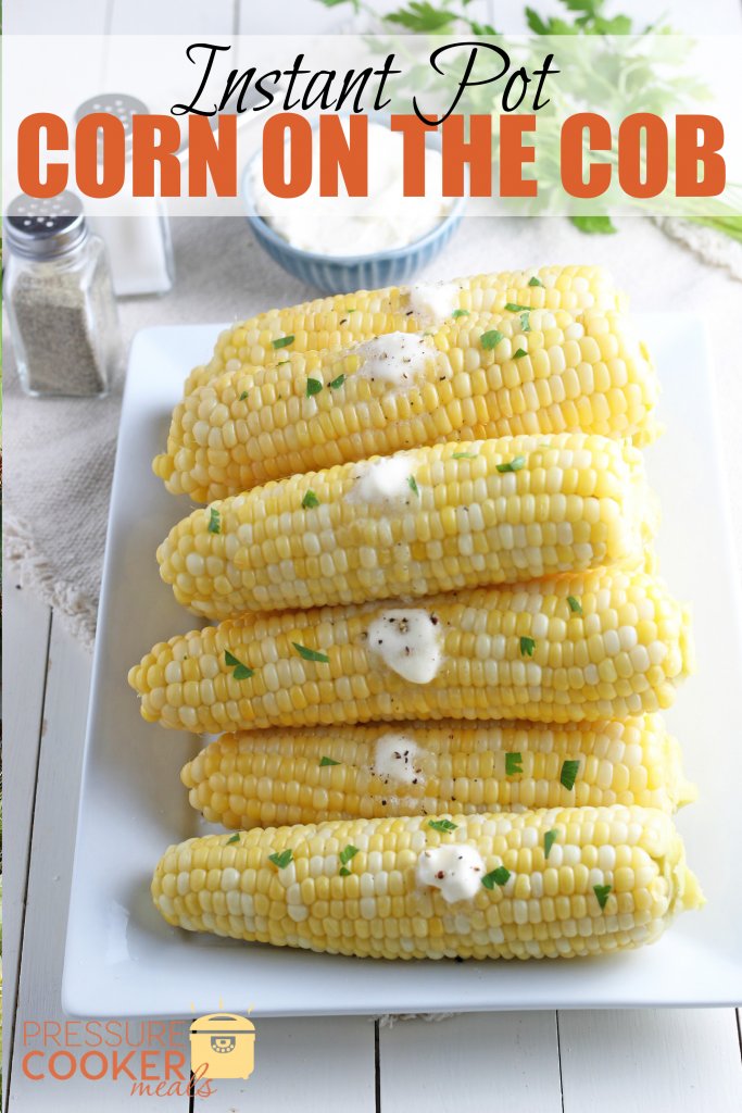 Instant Pot Corn on the Cob with butter and fresh cilantro stacked on a plate.